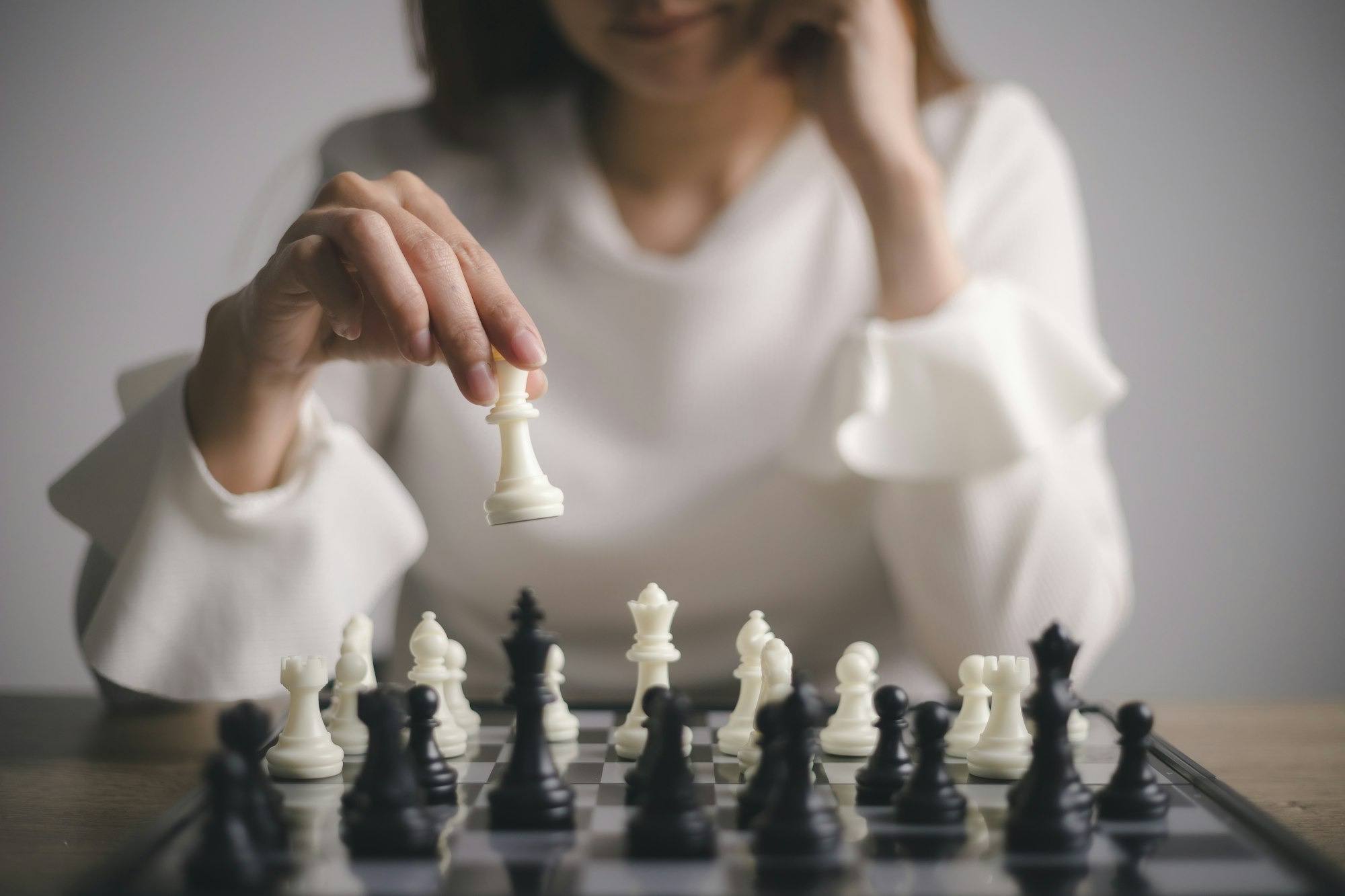 Businesswoman plays with chess game. concept of business strategy and tactic. strategy, management,